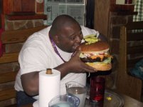 fat guy eating giant hamburger.jpg